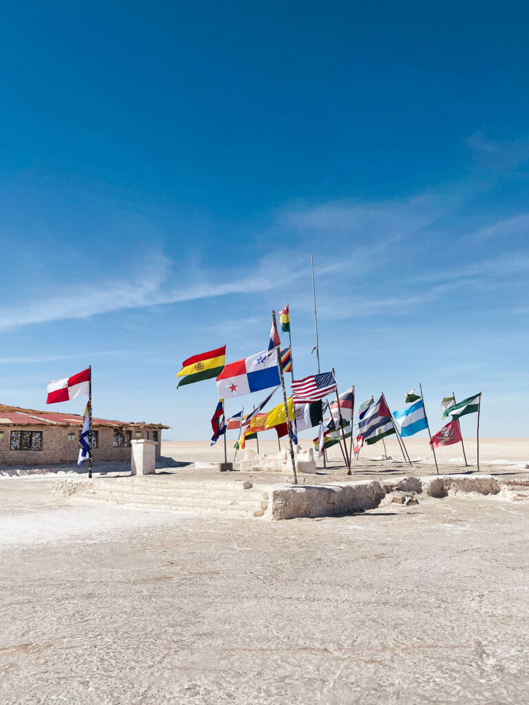 Bolivia Salar de Uyuni: world flags fluttering in the wind on the salar, an iconic site of the Bolivian Altiplano.