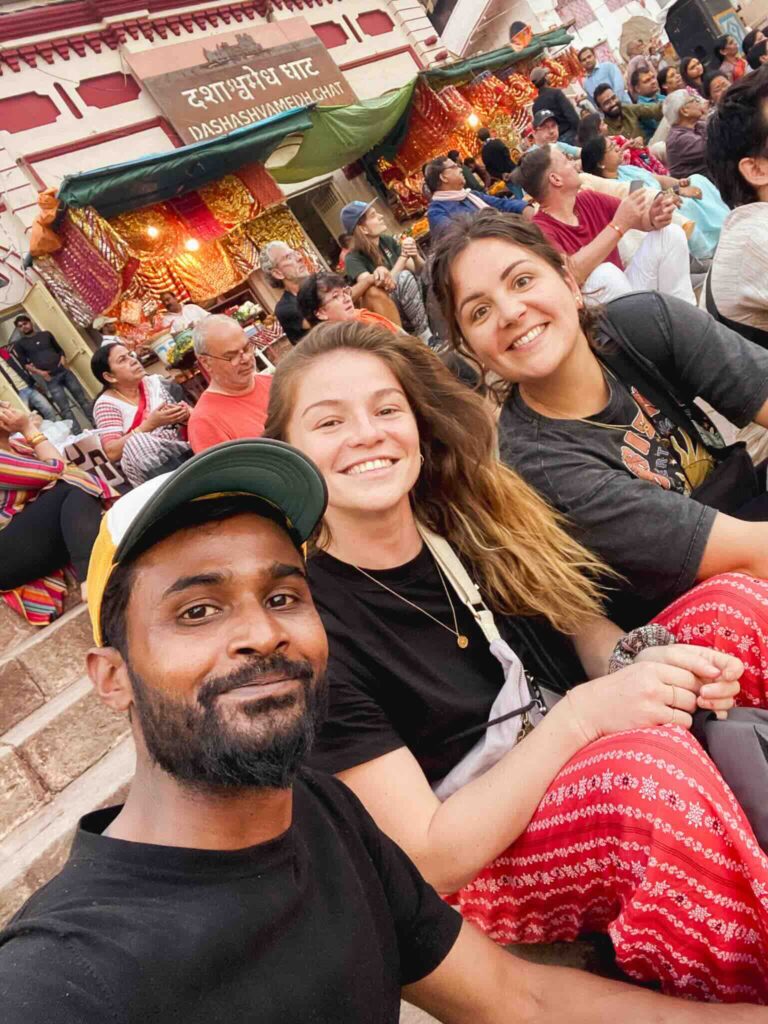 Eva, Manon, and their Indian guide Manish during a traditional religious ceremony in Varanasi.