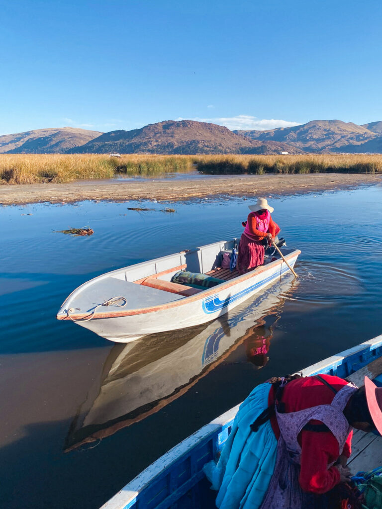 Local woman in a boat on Lake Titicaca near Puno, Peru.