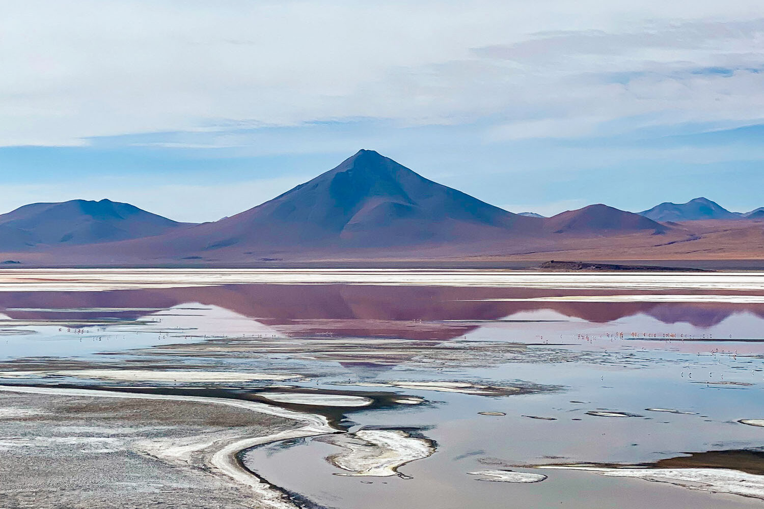 Colorful lagoon in the South Lipez, Bolivia, near Salar de Uyuni, a unique Altiplano landscape with deserts, mountains, and red and turquoise reflections.