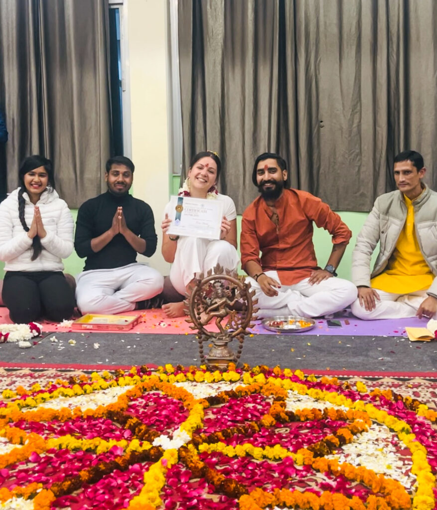 Eva receiving her teaching diploma at the graduation ceremony of her yoga training in Rishikesh, India