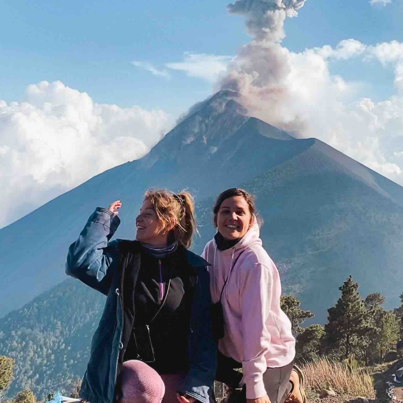 Eva and Manon in front of El Fuego volcano erupting in Guatemala
