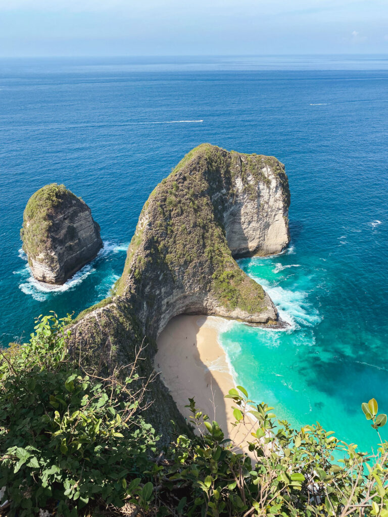 Aerial view of Kelingking Beach in Nusa Penida, famous for its T-Rex-shaped cliff.