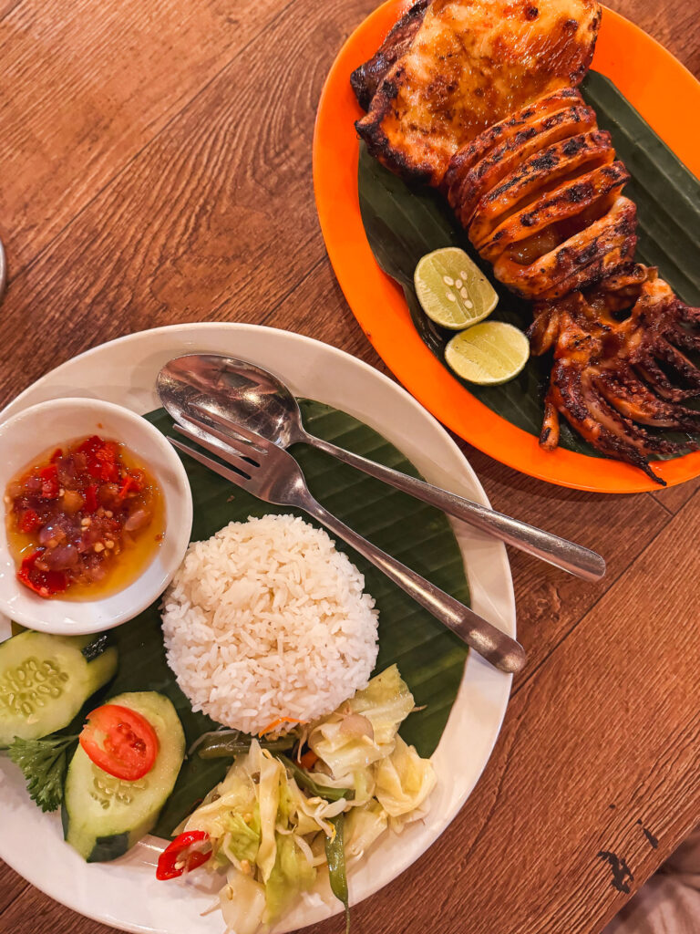 Grilled octopus with rice and vegetables at a warung.