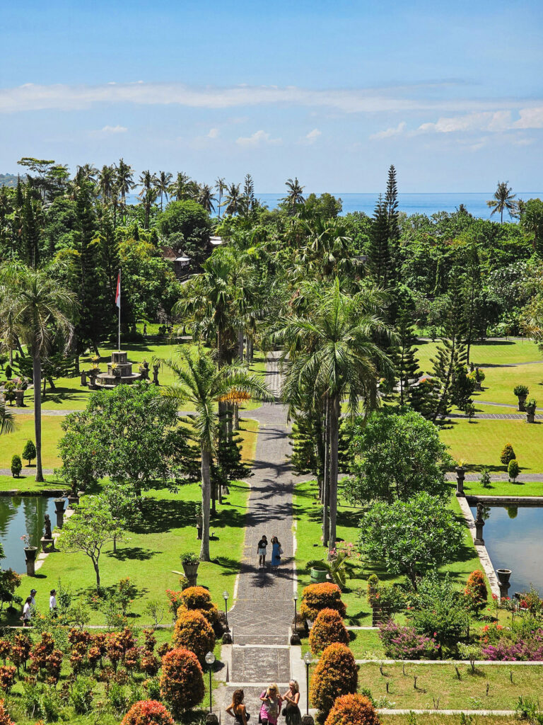 Panorama of Taman Ujung in Bali, with palace, gardens, and ocean in the background.