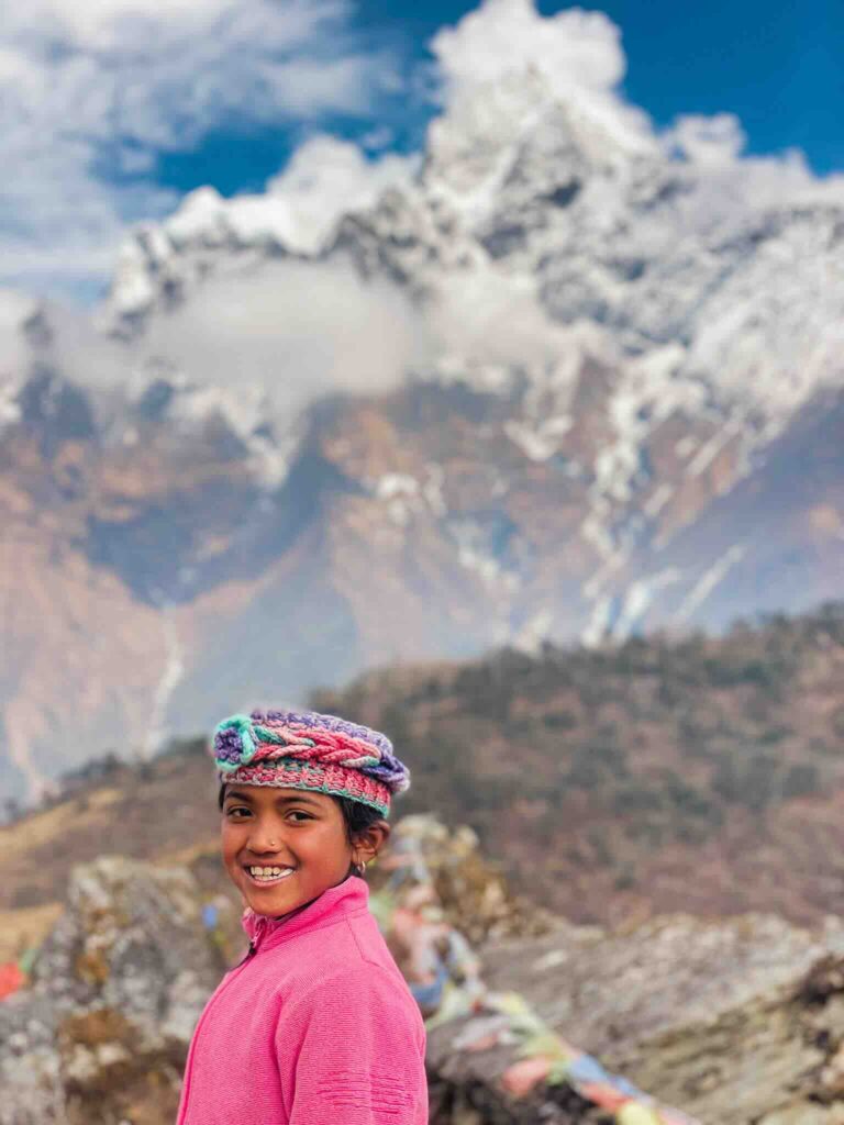Portrait of a young Nepalese girl with Himalayan mountains in the background, Nepal.