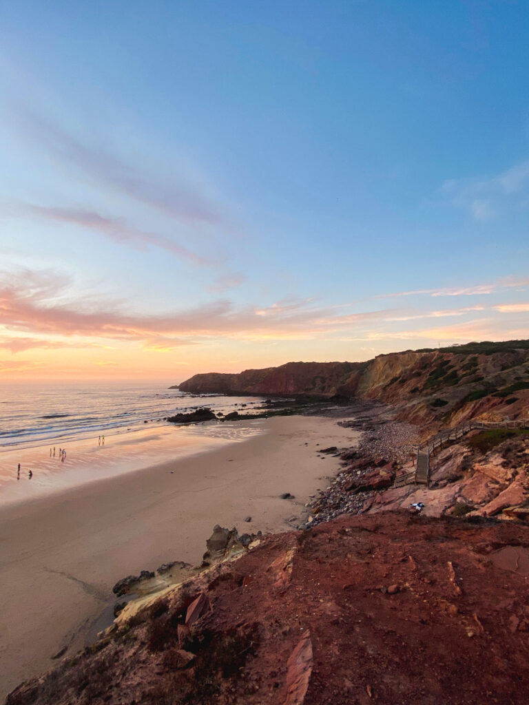 Sunset at Praia do Amado in Portugal, with its waves and golden sand.