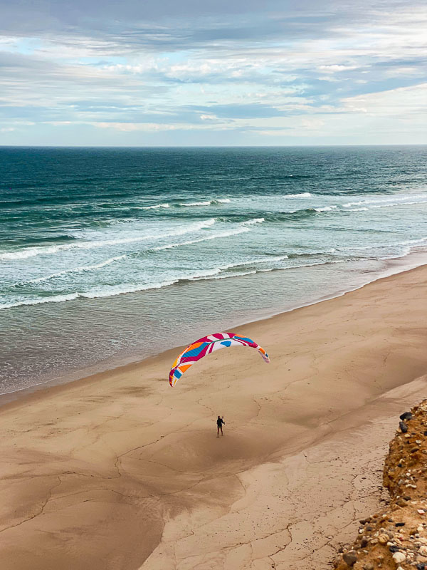 Paragliding take-off on Praia da Estrela beach, Portugal.