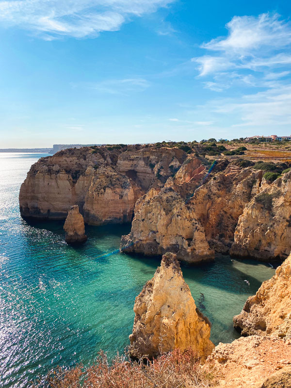Golden cliffs of the Algarve plunging into the ocean.