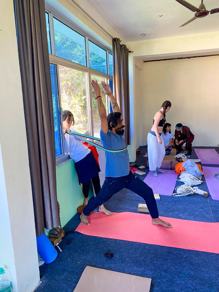 Yoga teacher leading a training class and teaching poses in Rishikesh, India