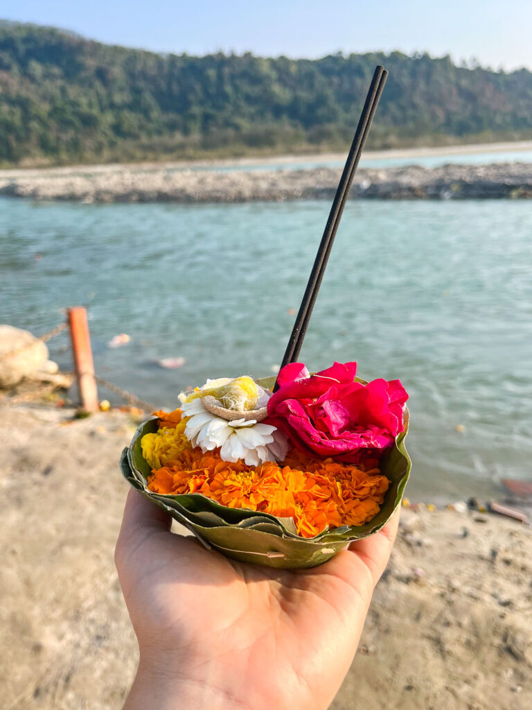 Flower and incense offering ritual by the Ganges in Rishikesh, India