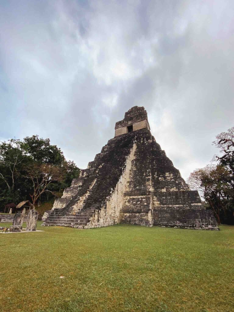 View of a Mayan ruin in Tikal Guatemala surrounded by lush vegetation
