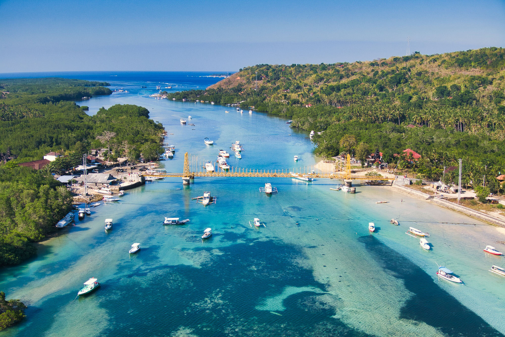 Drone view of the iconic yellow bridge connecting Nusa Lembongan to Nusa Penida.