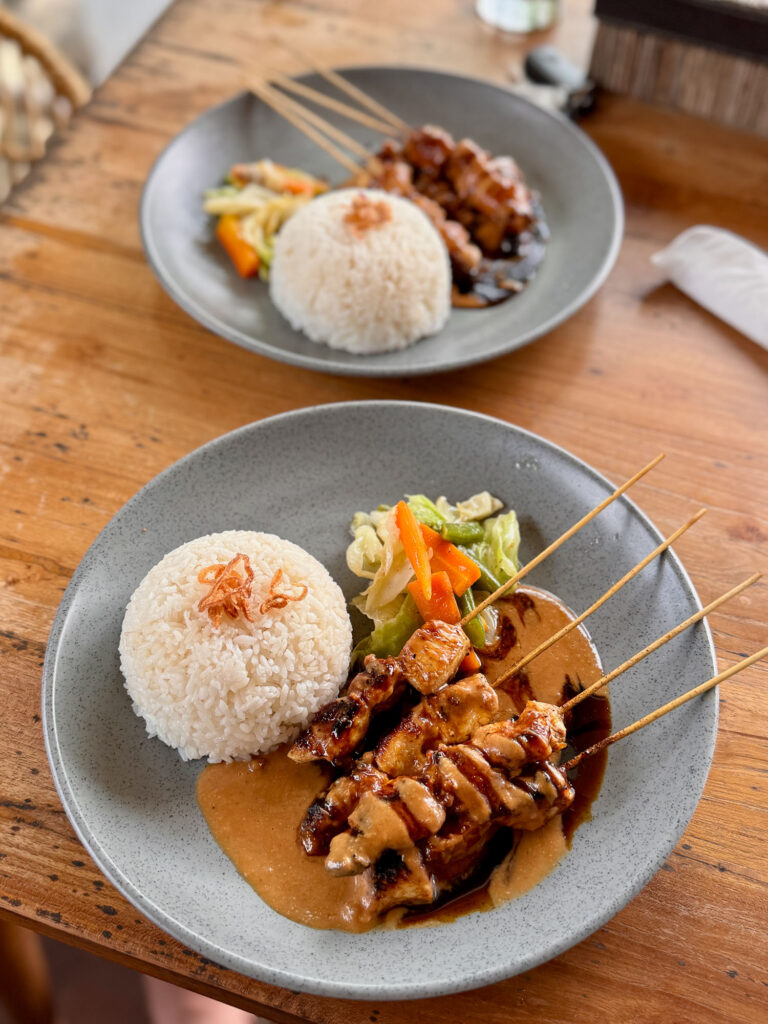 Chicken satay with rice and vegetables in a warung.